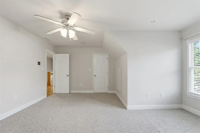 a living room with furniture and a lamp