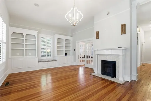a view of a livingroom with wooden floor and a ceiling fan