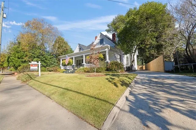 a view of a house with a yard and garden