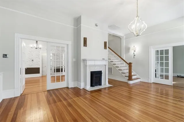 a view of a hallway with wooden floor and a fireplace