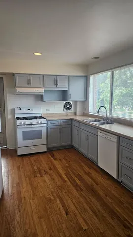 a kitchen with stainless steel appliances granite countertop a sink and a stove top oven