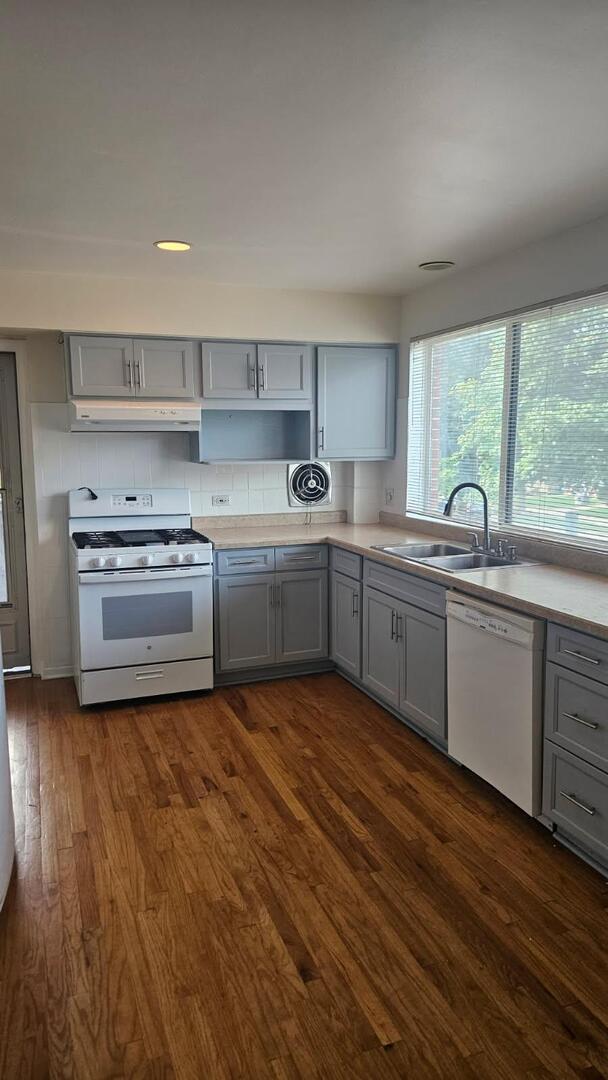 611 Wesley Avenue, Unit 1 Evanston, IL 60202 - Photo 5 of 8 a kitchen with stainless steel appliances granite countertop a sink and a stove top oven