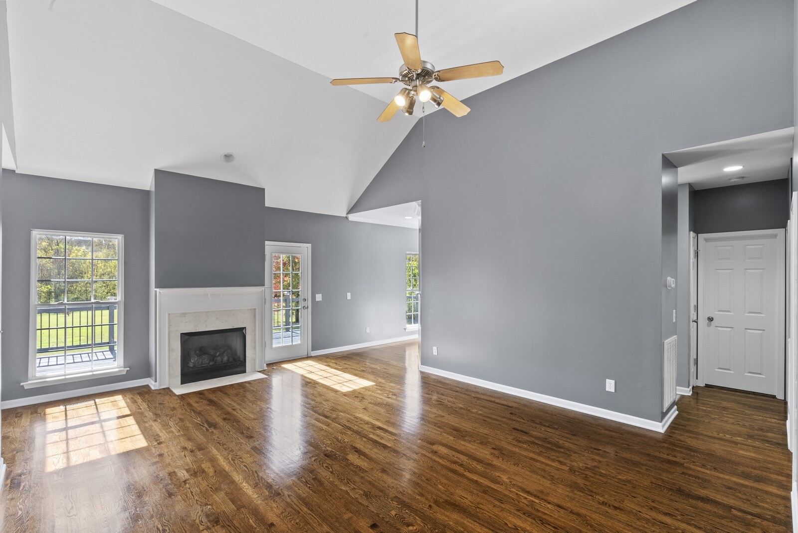 450 Brown Road Lebanon, TN 37087 - Photo 7 of 37 an empty room with wooden floor a chandelier fan and windows