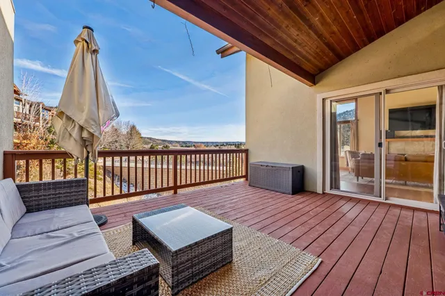a view of a deck with wooden floor and outdoor seating