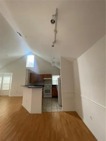 a view of a kitchen with a sink wooden floor and a living room