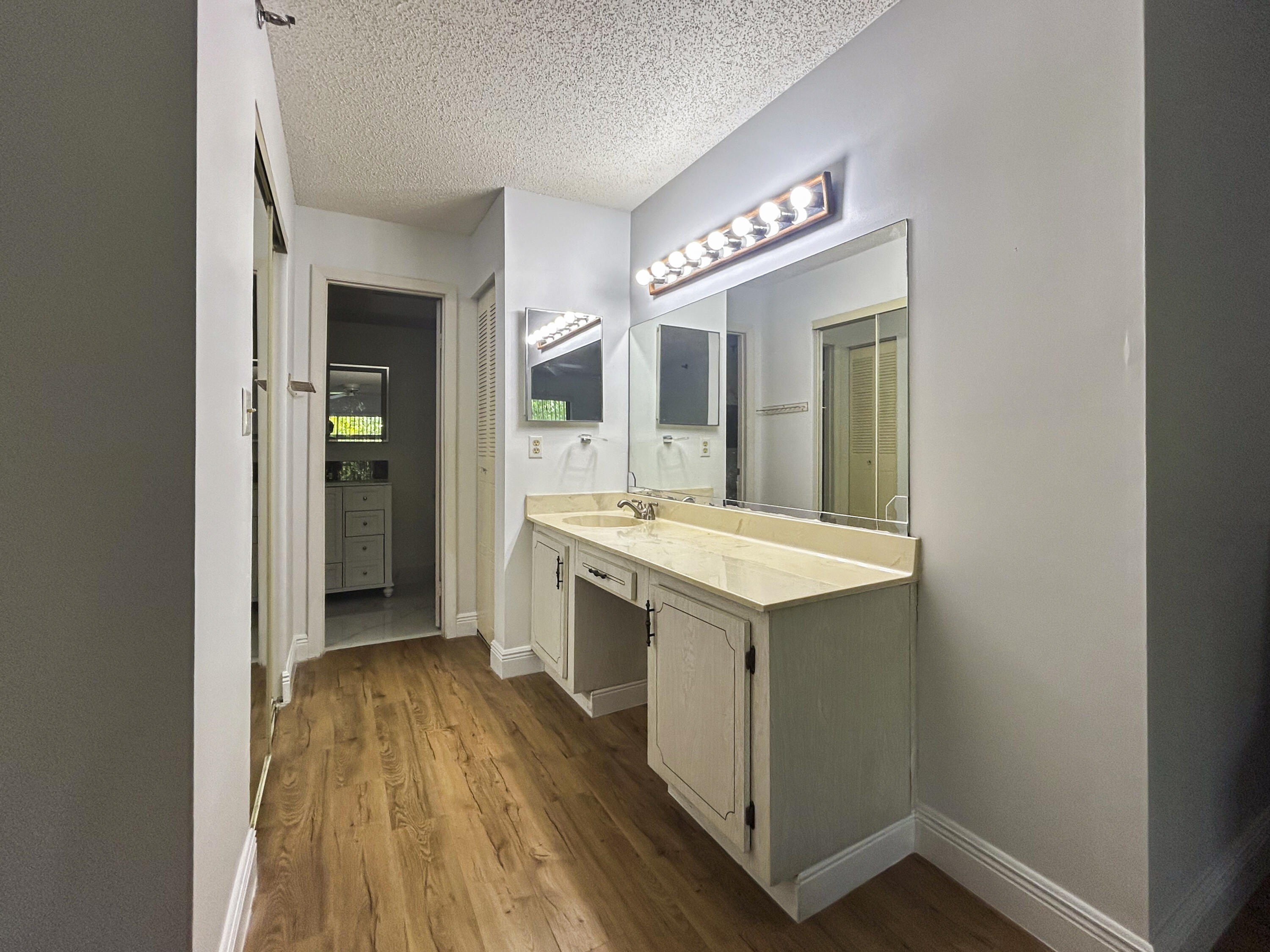 9235 Southwest 8th Street, Unit 114 Boca Raton, FL 33428 - Photo 12 of 18 a bathroom with a sink and a mirror