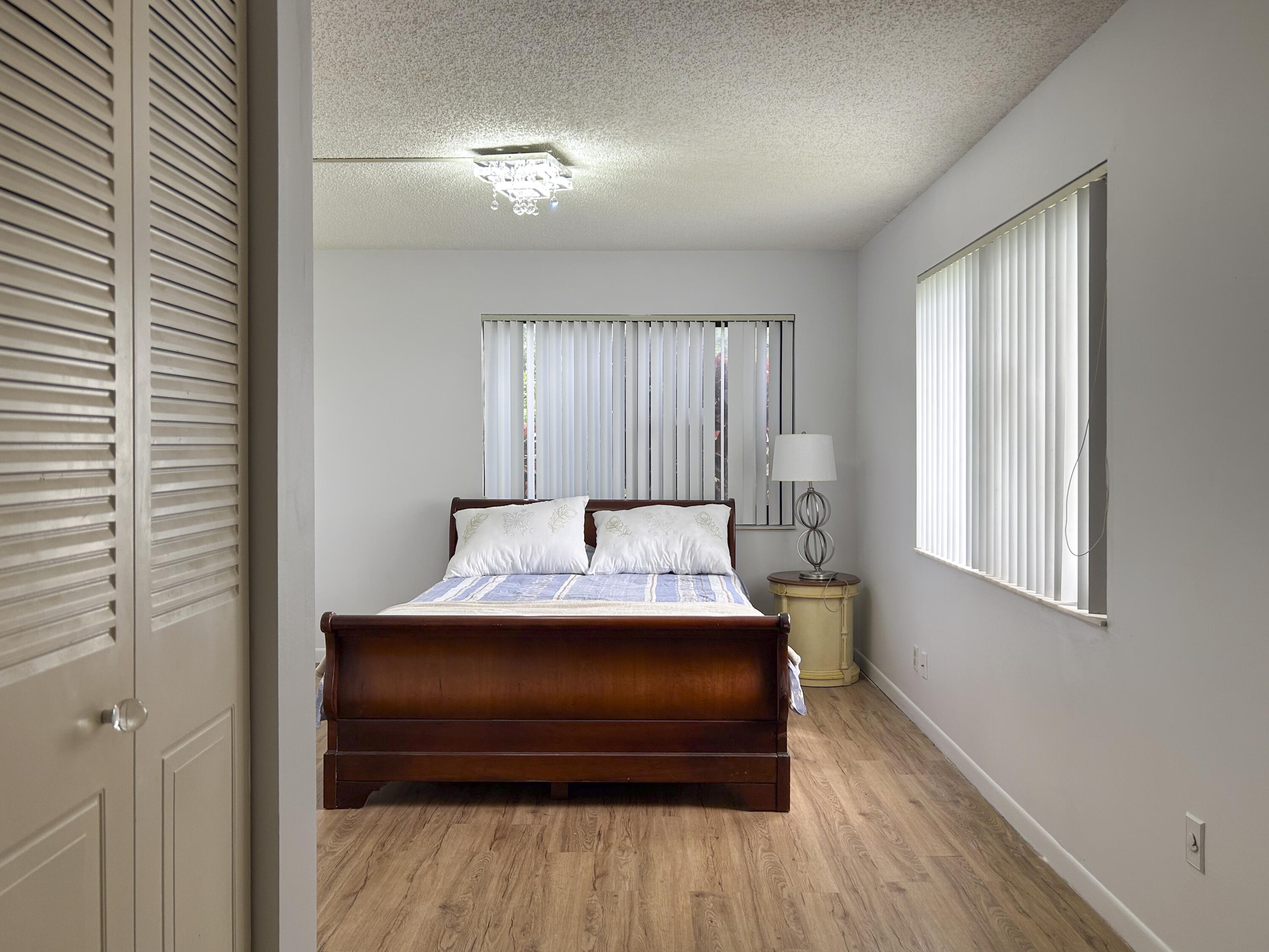 9235 Southwest 8th Street, Unit 114 Boca Raton, FL 33428 - Photo 15 of 18 a bedroom with a bed and window