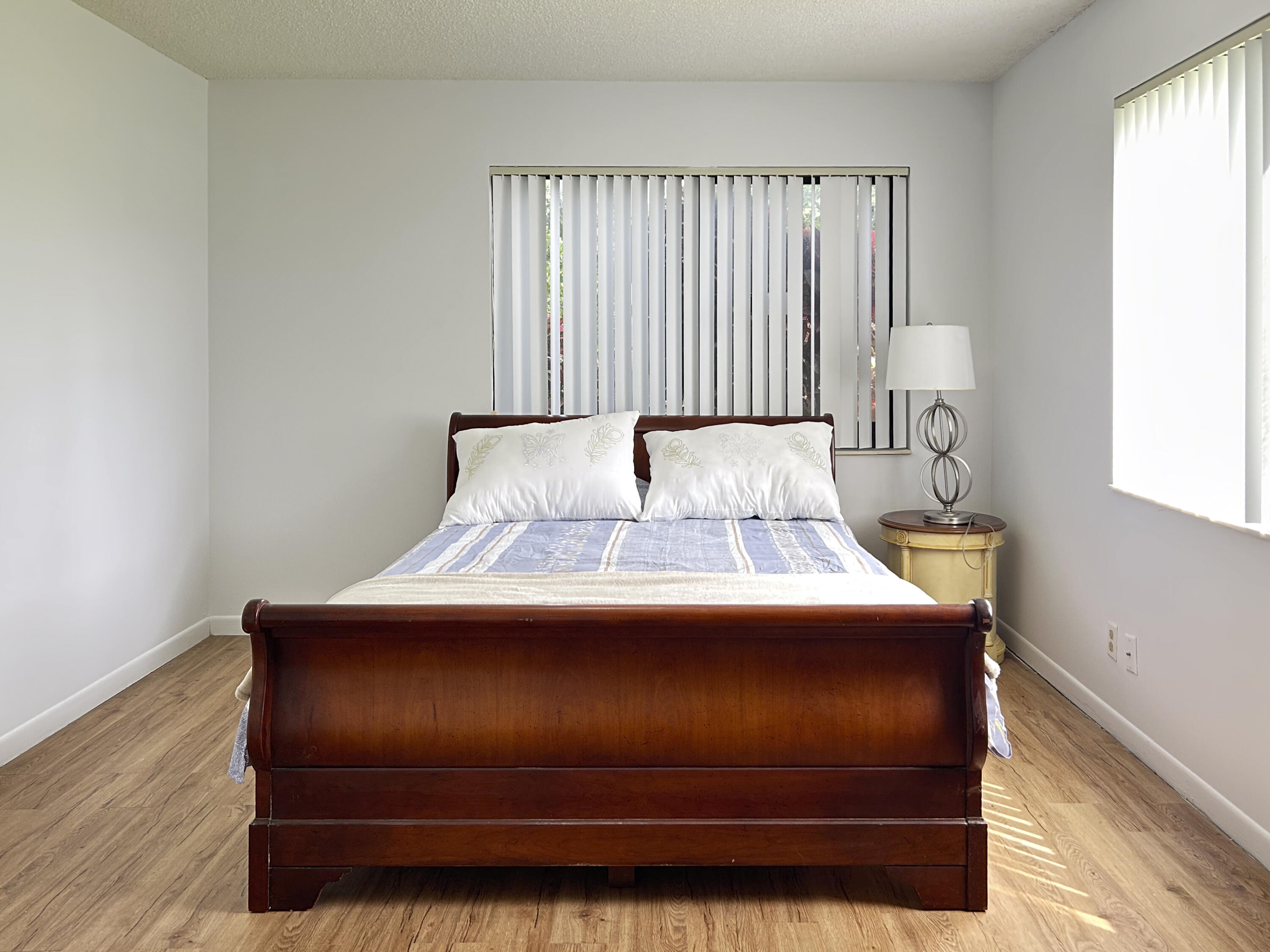 9235 Southwest 8th Street, Unit 114 Boca Raton, FL 33428 - Photo 16 of 18 a bedroom with a bed and window