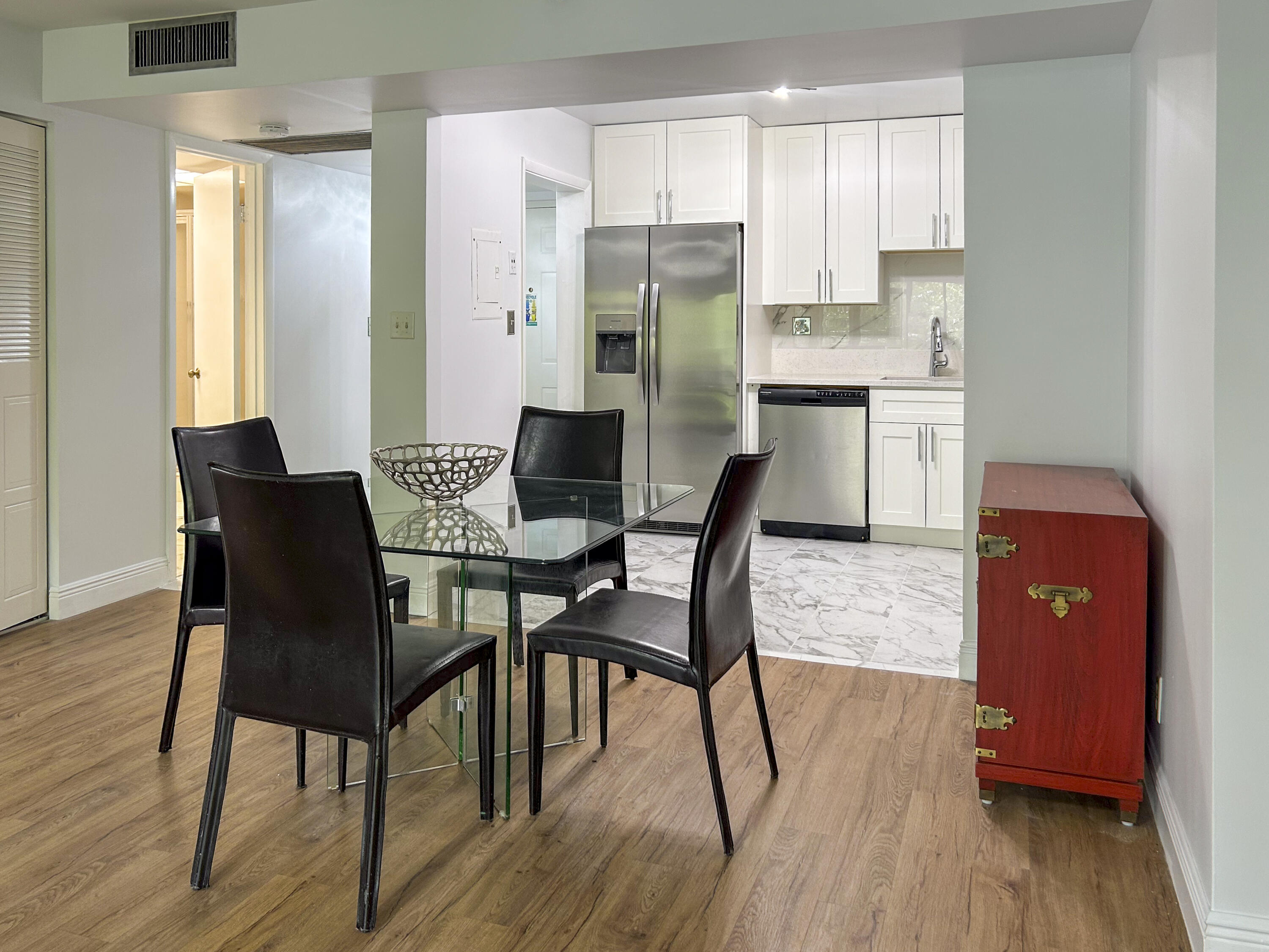 9235 Southwest 8th Street, Unit 114 Boca Raton, FL 33428 - Photo 5 of 18 a view of a dining room with furniture and wooden floor