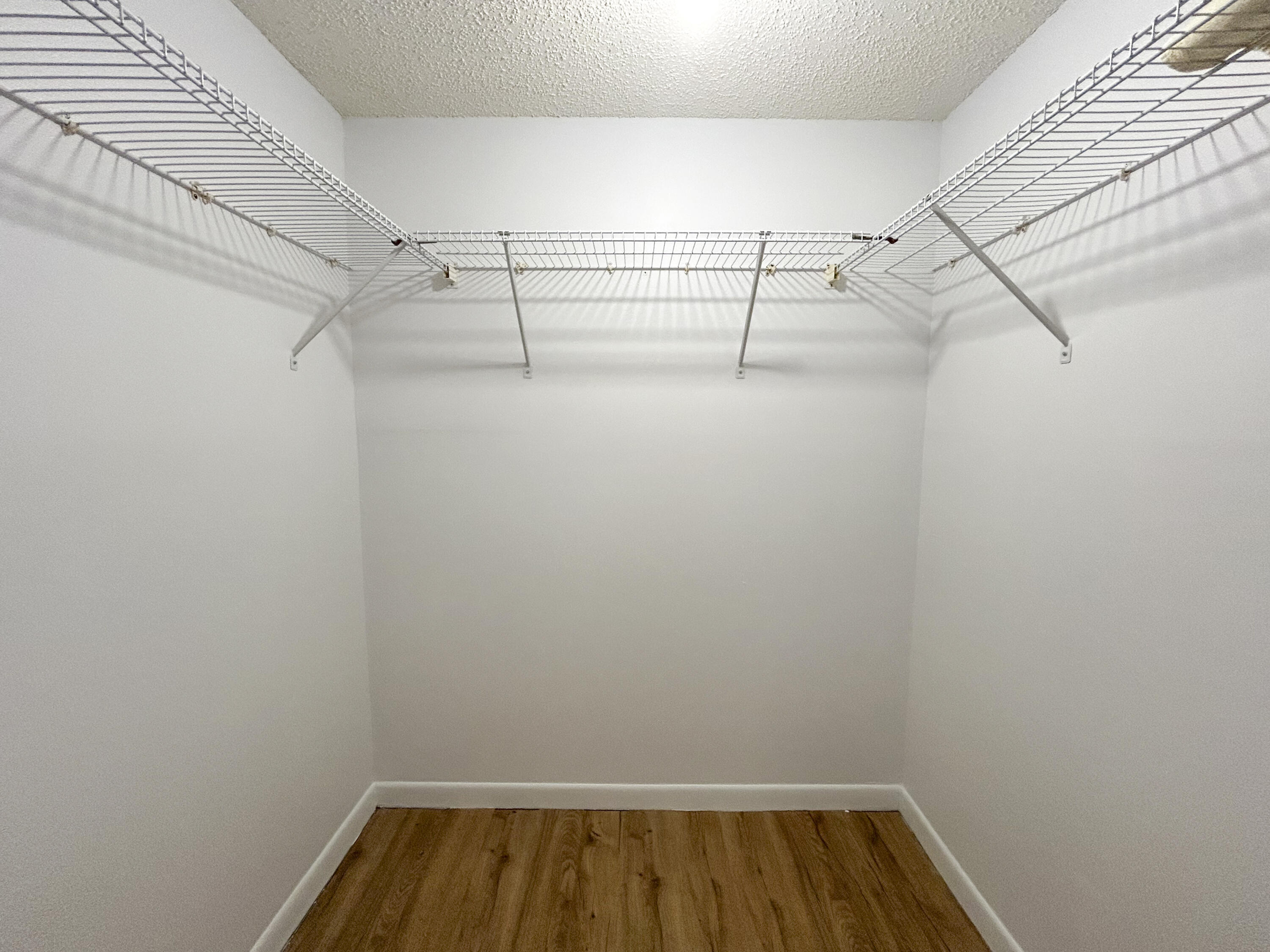 9235 Southwest 8th Street, Unit 114 Boca Raton, FL 33428 - Photo 9 of 18 a view of small space with racks on the wall