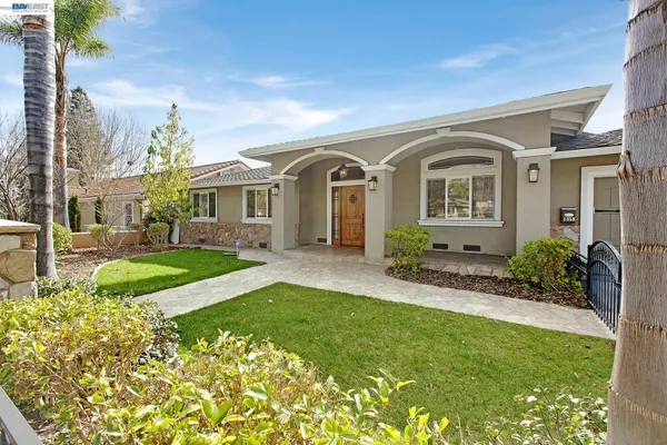 a front view of a house with a garden