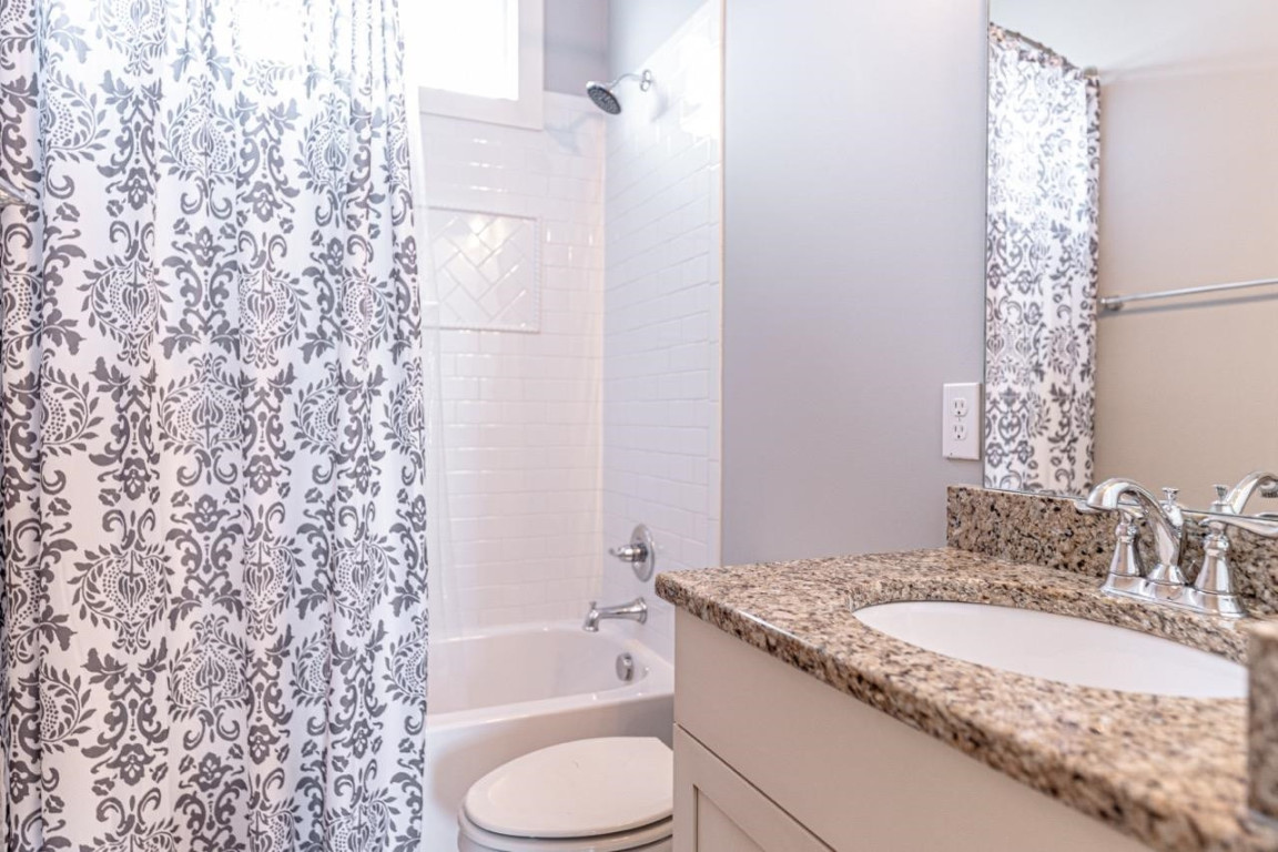 Undisclosed Address Raleigh, NC 27605 - Photo 18 of 29 a bathroom with a granite countertop sink toilet and shower