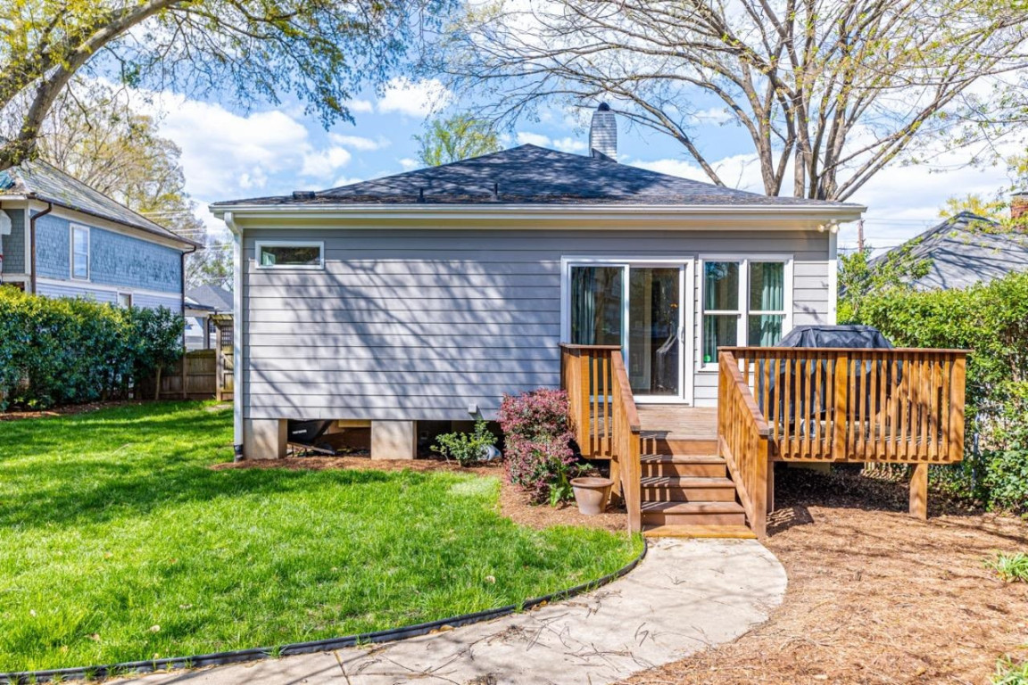 Undisclosed Address Raleigh, NC 27605 - Photo 22 of 29 a view of a chair and table in backyard of the house