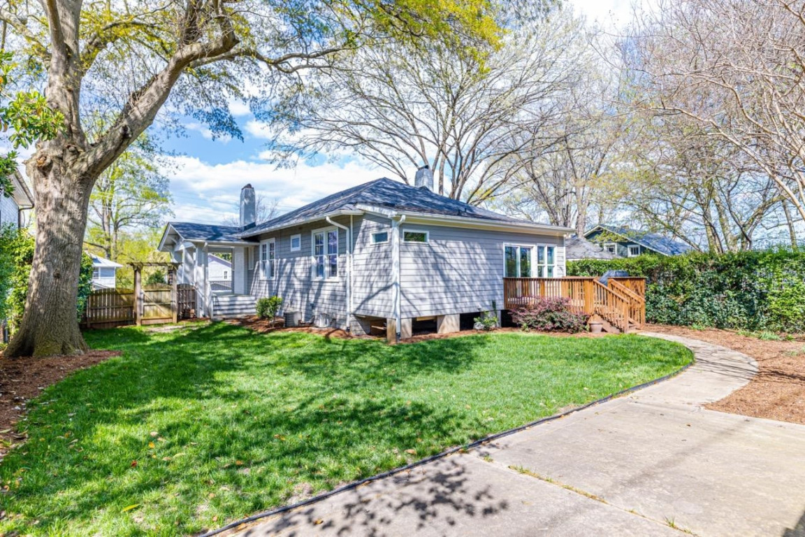 Undisclosed Address Raleigh, NC 27605 - Photo 23 of 29 a view of a house with a yard