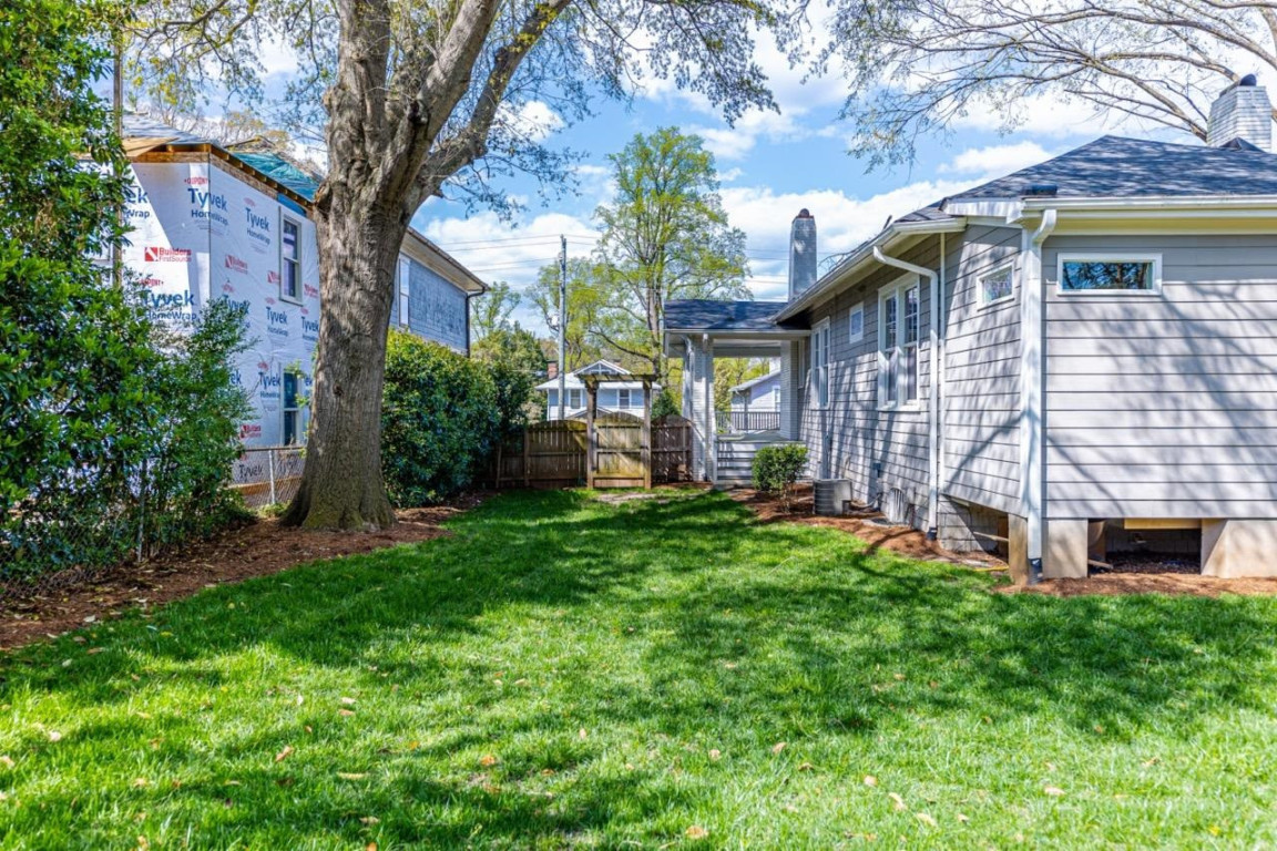 Undisclosed Address Raleigh, NC 27605 - Photo 24 of 29 a view of a house with a yard