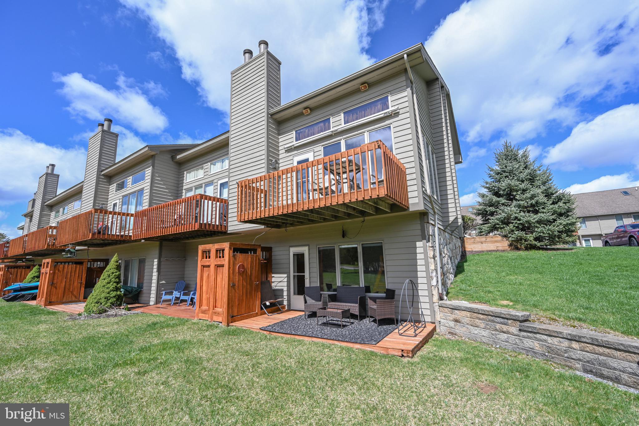 a view of a chairs and table in front of house