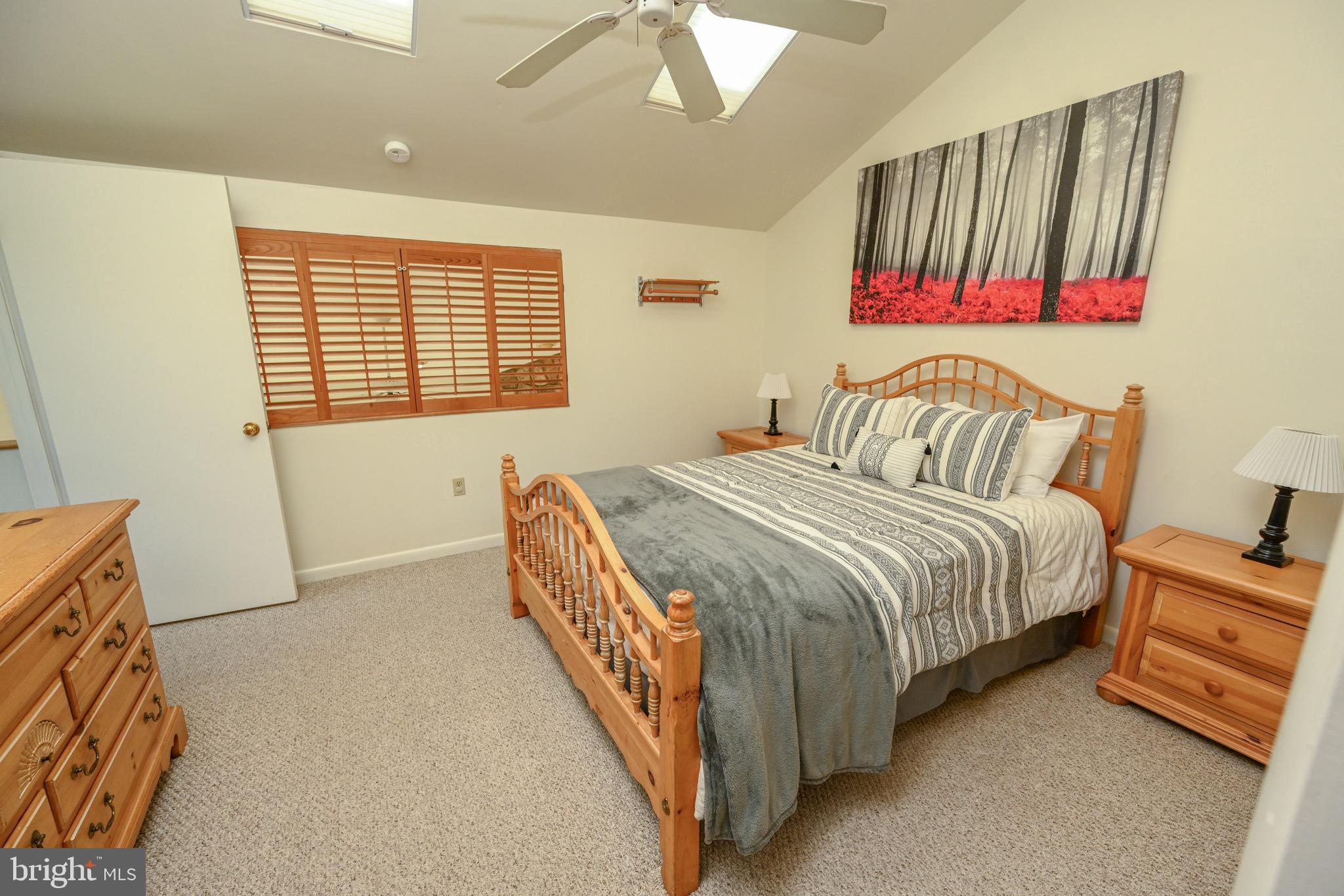 257 Marsh Hill Road, Unit 1 McHenry, MD 21541 - Photo 19 of 50 a bedroom with a bed and a night stand