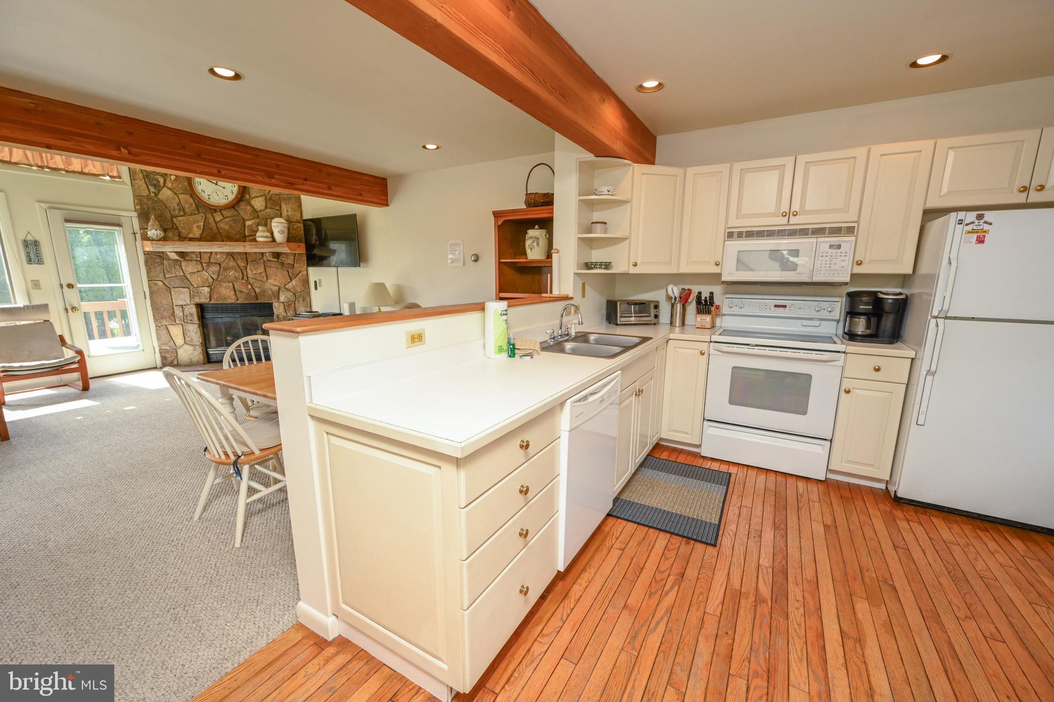 257 Marsh Hill Road, Unit 1 McHenry, MD 21541 - Photo 6 of 50 a kitchen with white cabinets and white appliances