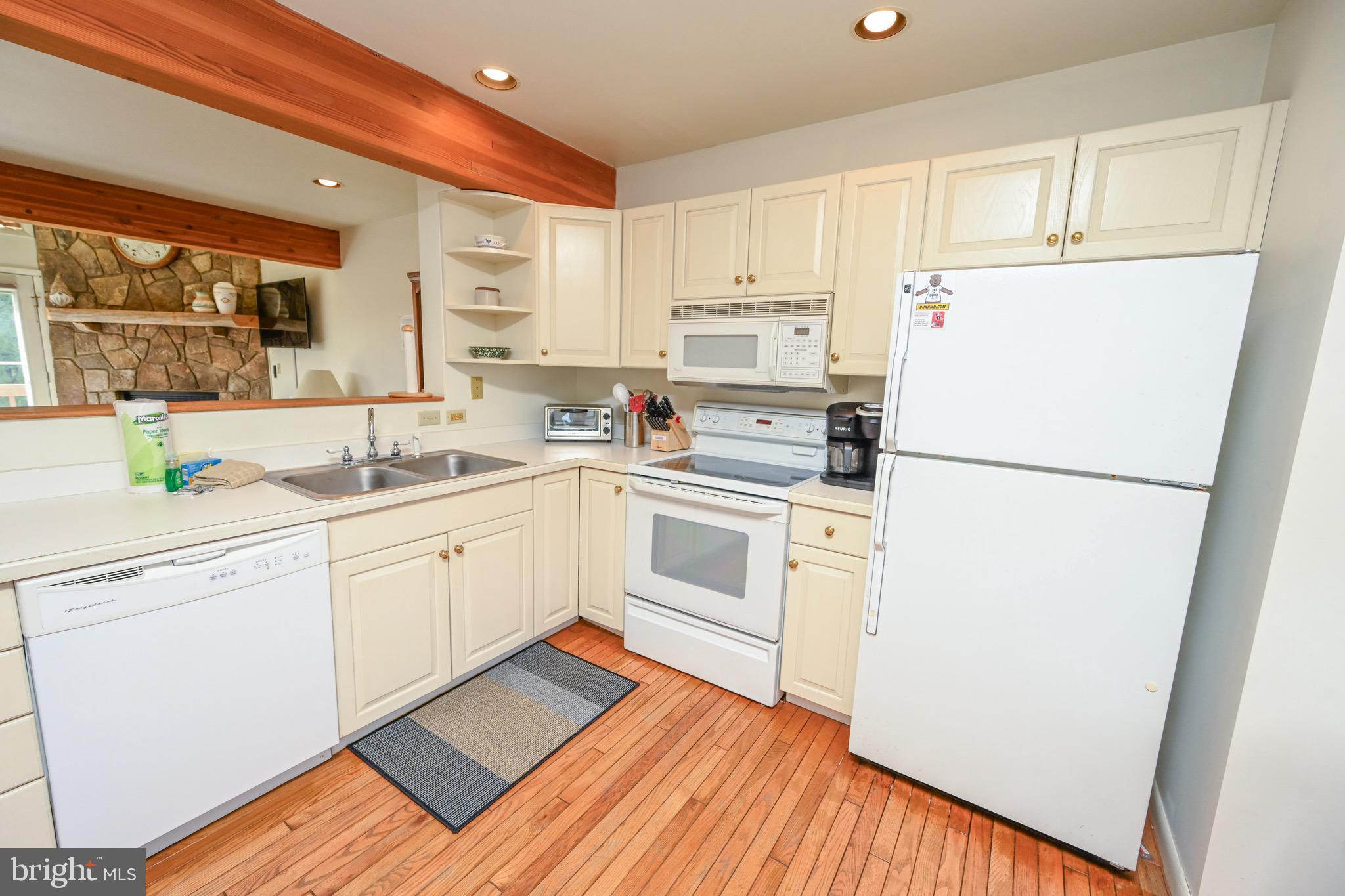 257 Marsh Hill Road, Unit 1 McHenry, MD 21541 - Photo 8 of 50 a kitchen with a white cabinets and white appliances