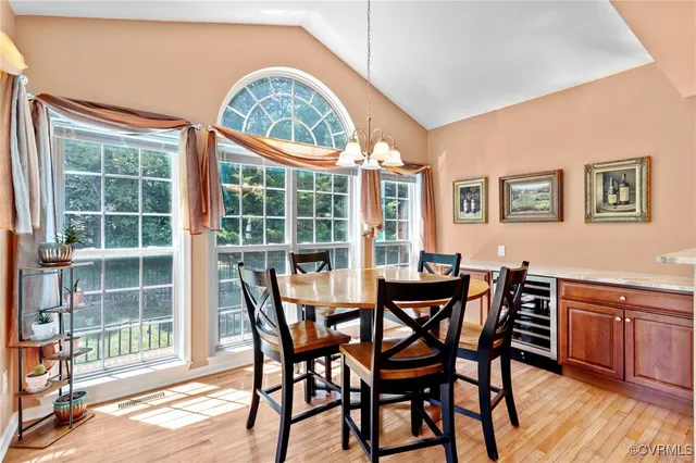 a view of a dining room with furniture large windows and wooden floor