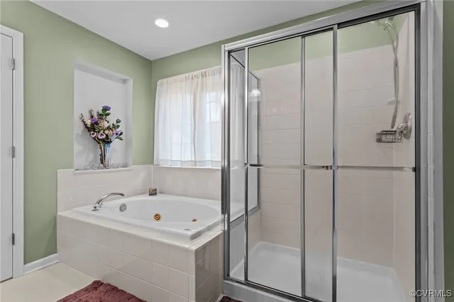 a bathroom with a bathtub and a shower