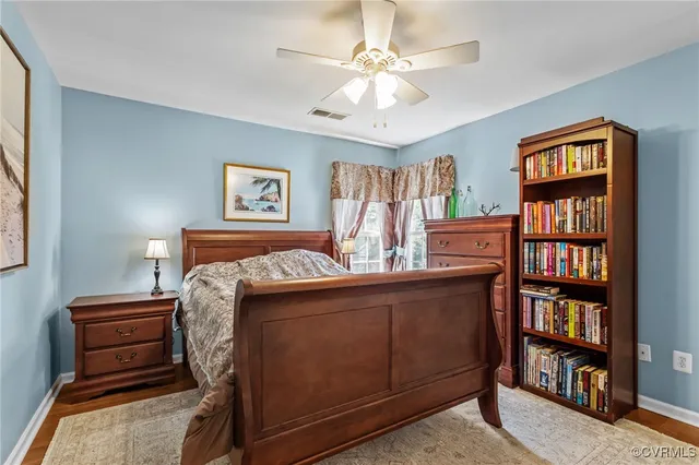 a bedroom with a bed and a book shelf