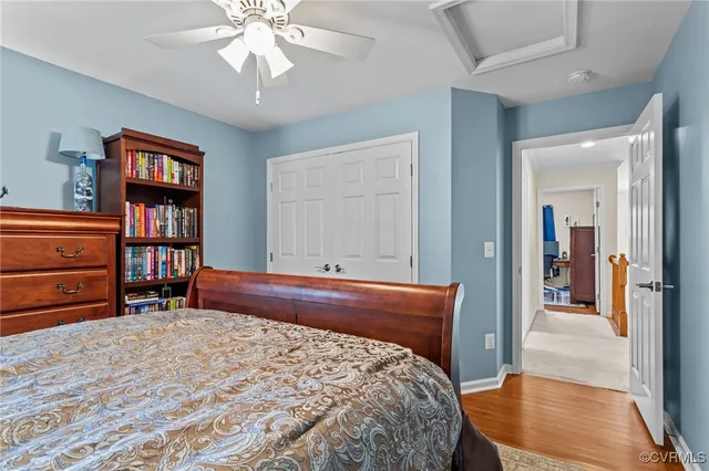 a bedroom with a bed a dresser and book shelf