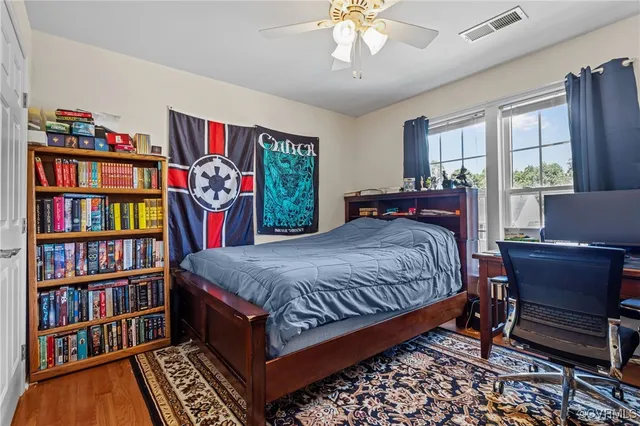 a bed room with a bed and a book shelf