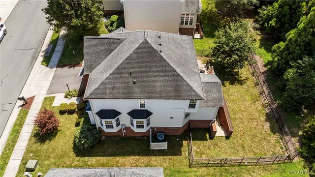 an aerial view of a house with swimming pool and sitting area
