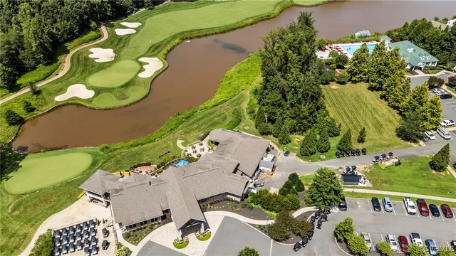 an aerial view of residential houses with outdoor space and trees