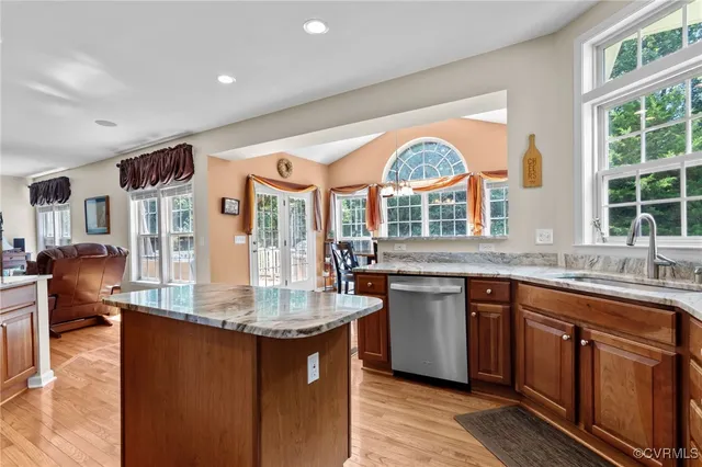 a kitchen with stainless steel appliances granite countertop a stove and a sink
