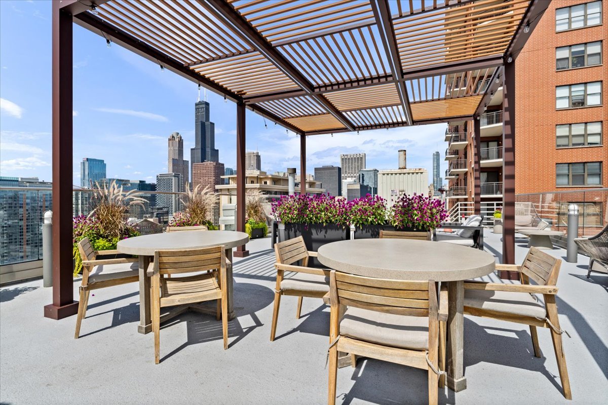 40 East 9th Street, Unit 1303 Chicago, IL 60605 - Photo 18 of 20 a patio with a table and chairs and potted plants