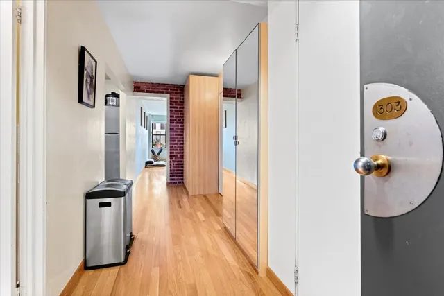 a view of a hallway with wooden floor