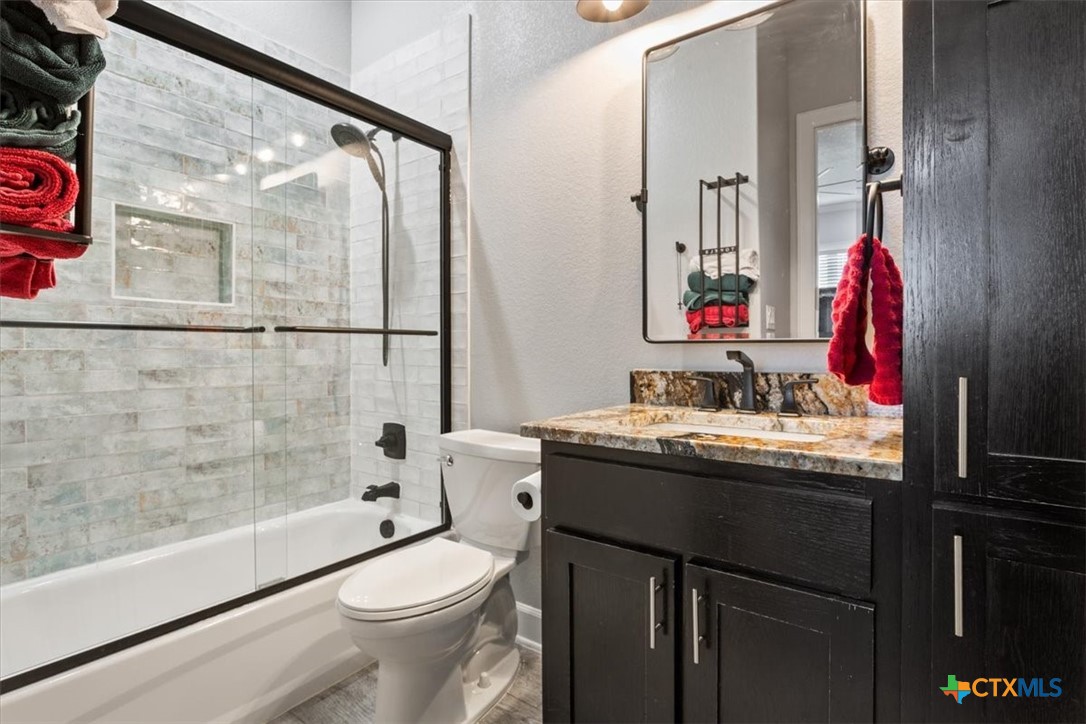 10940 Wedel Cemetery Road Rogers, TX 76569 - Photo 26 of 48 a bathroom with a granite countertop sink toilet and shower