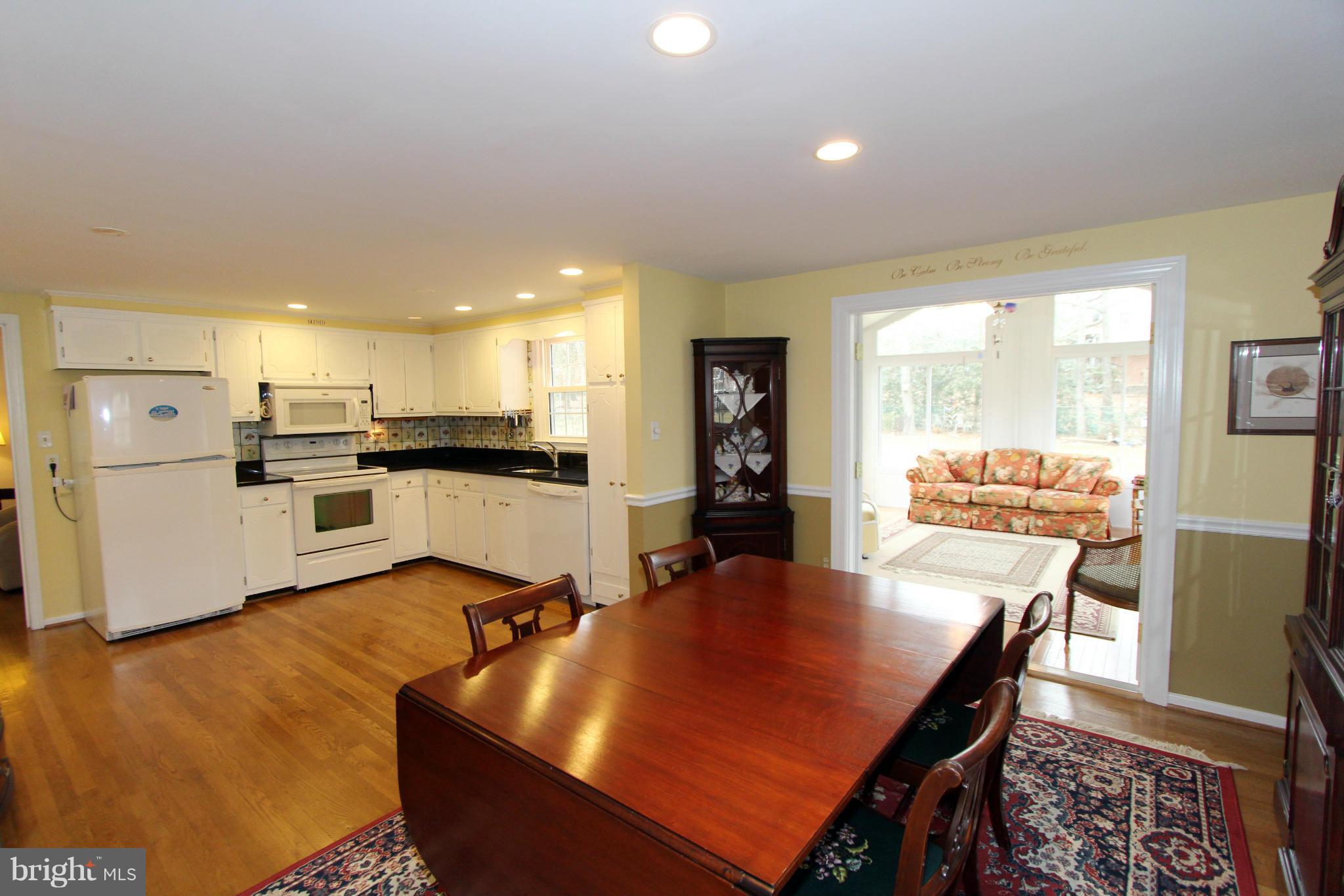 2000 Byrd Road Vienna, VA 22182 - Photo 13 of 30 a kitchen with stainless steel appliances granite countertop a stove a refrigerator a kitchen island a table and chairs