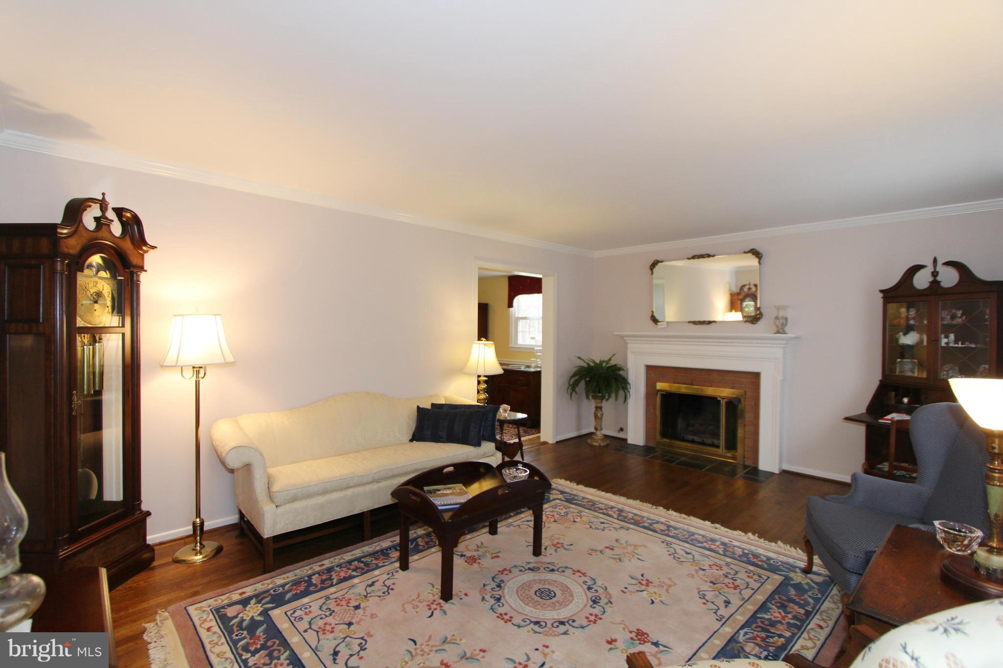 2000 Byrd Road Vienna, VA 22182 - Photo 16 of 30 a living room with furniture a fireplace and a flat screen tv