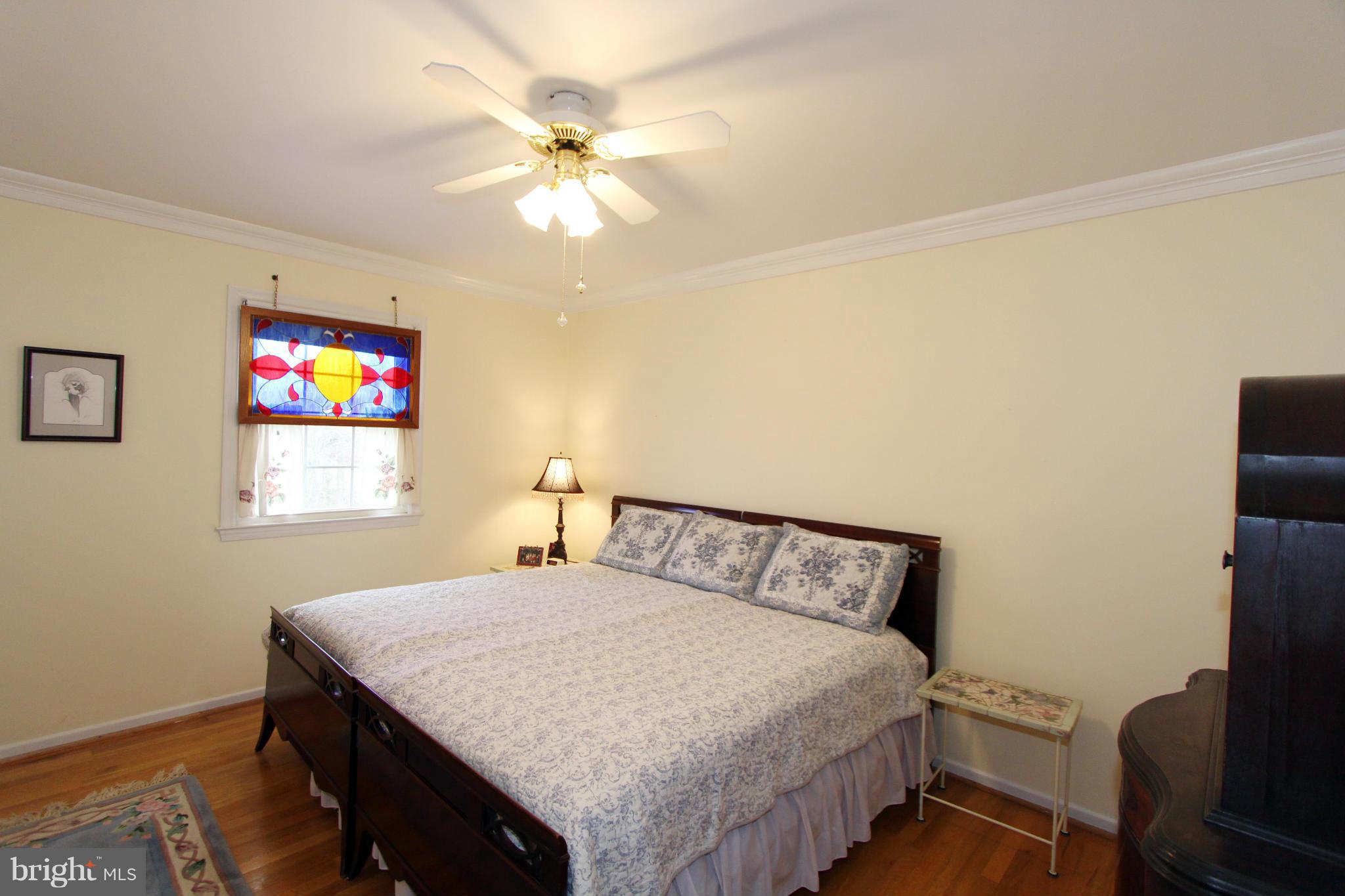 2000 Byrd Road Vienna, VA 22182 - Photo 24 of 30 a bedroom with a bed and a chandelier