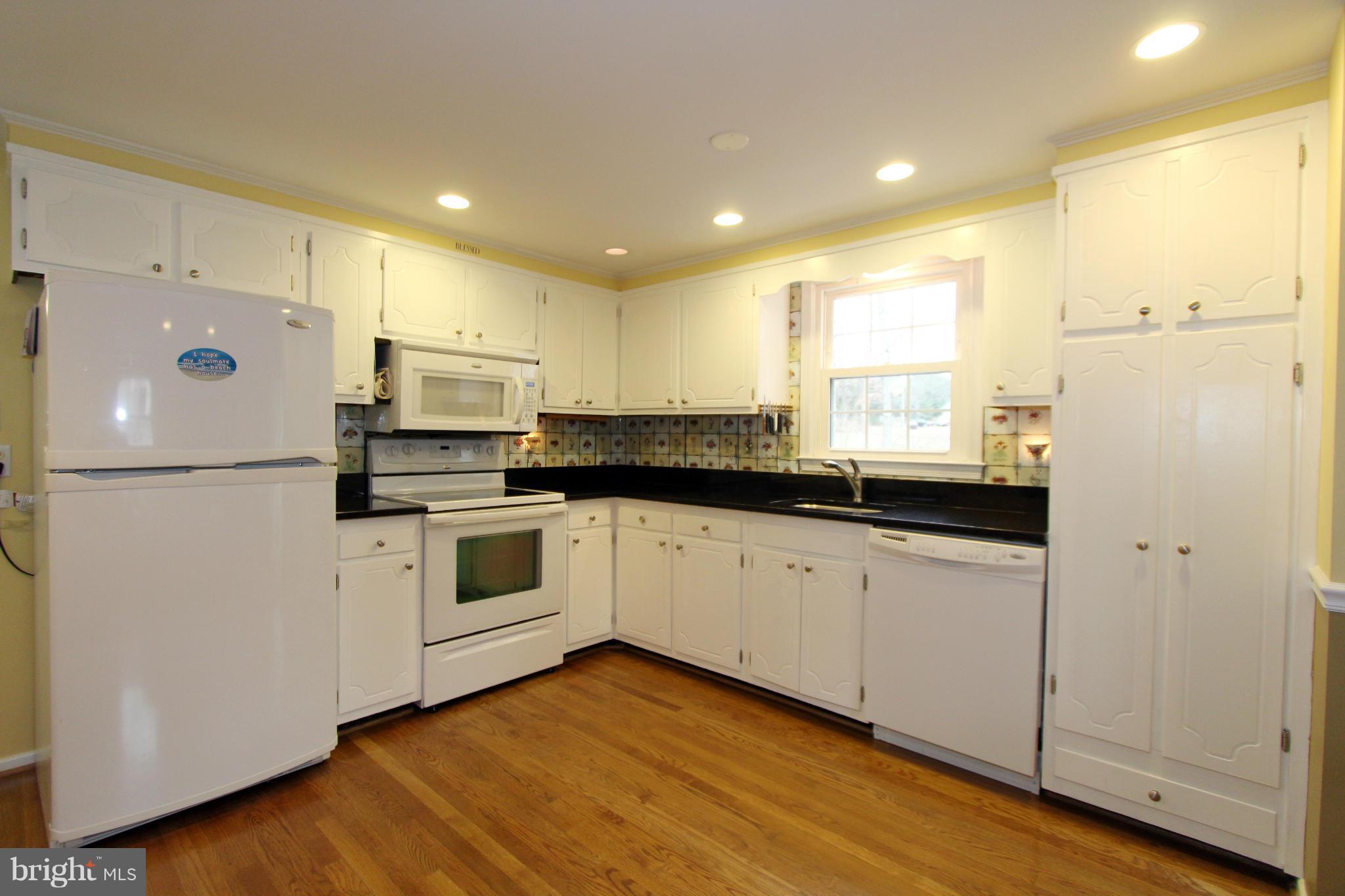 2000 Byrd Road Vienna, VA 22182 - Photo 8 of 30 a kitchen with white cabinets and white appliances