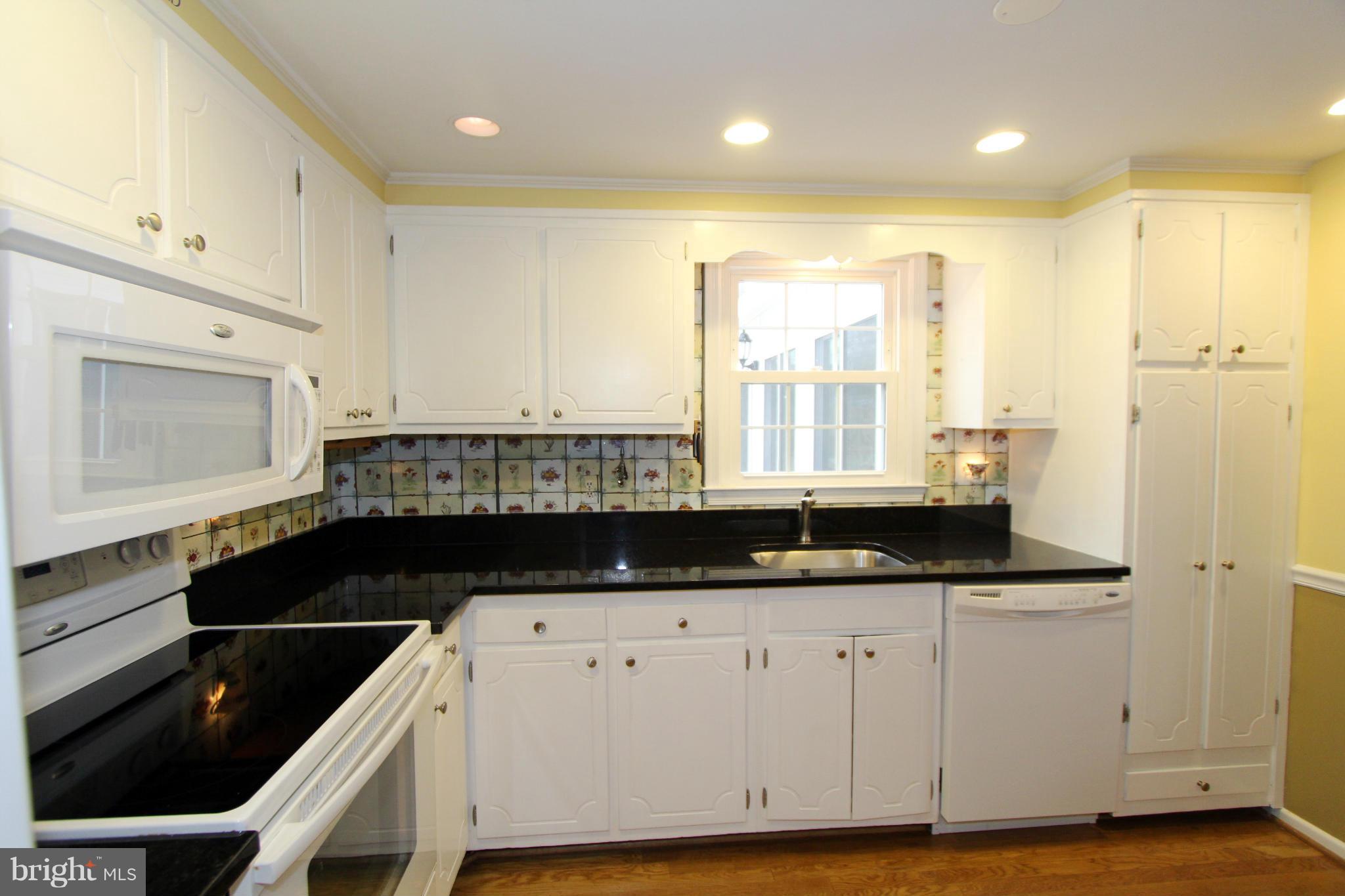 2000 Byrd Road Vienna, VA 22182 - Photo 9 of 30 a kitchen with granite countertop a stove a sink and a microwave