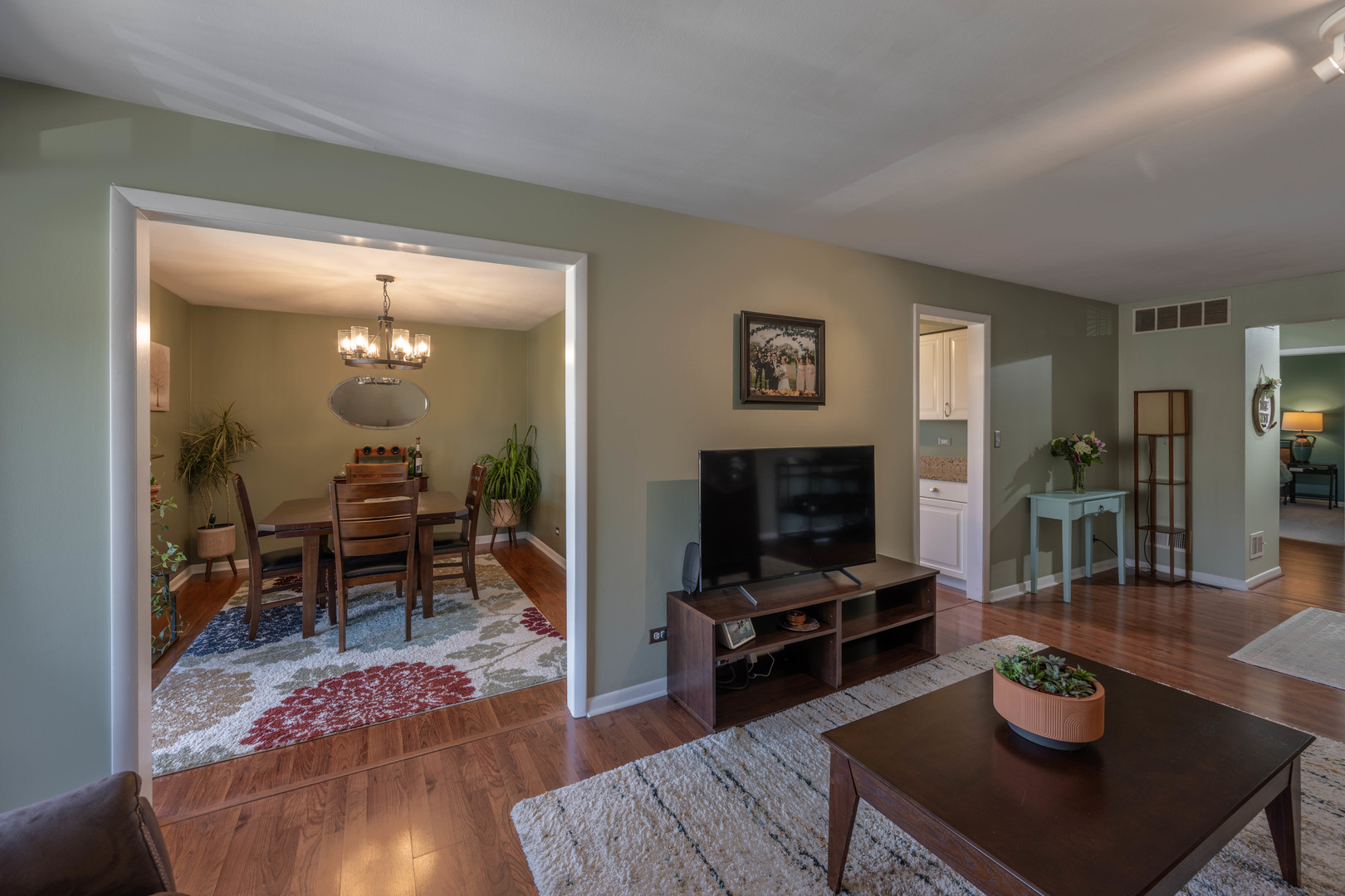 1495 South County Farm Road, Unit 23 Wheaton, IL 60189 - Photo 13 of 21 a living room with furniture and a flat screen tv