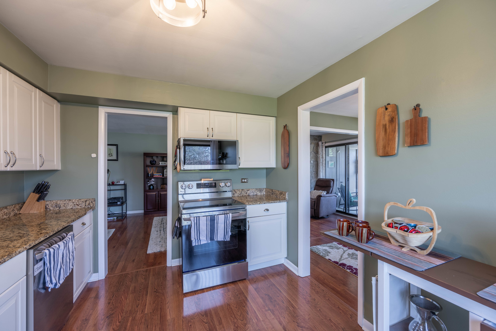 1495 South County Farm Road, Unit 23 Wheaton, IL 60189 - Photo 18 of 21 a kitchen with stainless steel appliances granite countertop a refrigerator a stove top oven and a sink