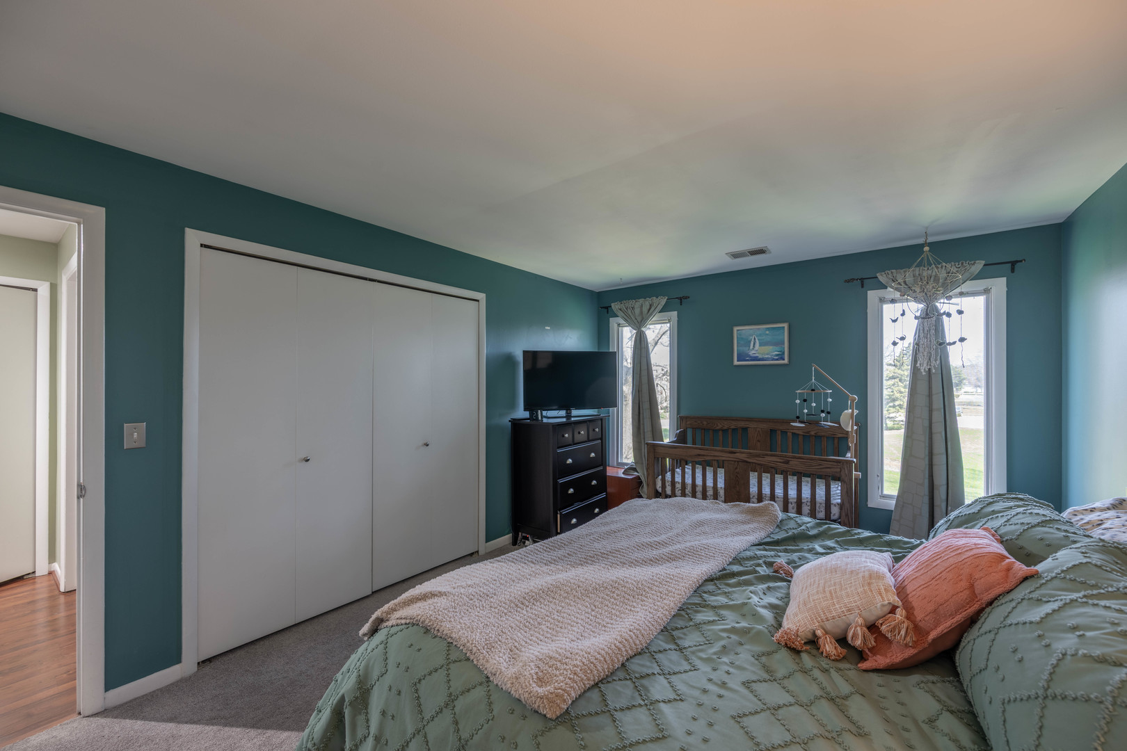 1495 South County Farm Road, Unit 23 Wheaton, IL 60189 - Photo 8 of 21 a bedroom with a bed and a television