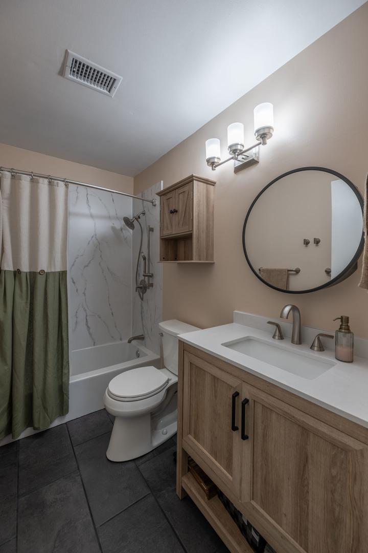 1495 South County Farm Road, Unit 23 Wheaton, IL 60189 - Photo 10 of 21 a bathroom with a granite countertop sink toilet a mirror and shower