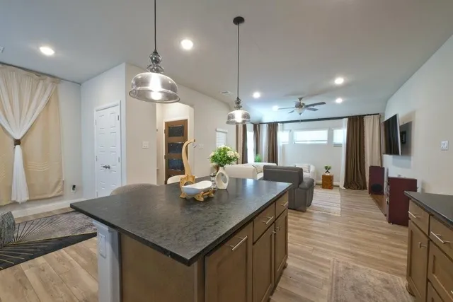a kitchen with center island table and chairs