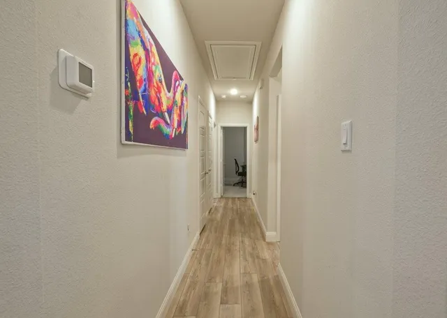 a view of a hallway with wooden floor