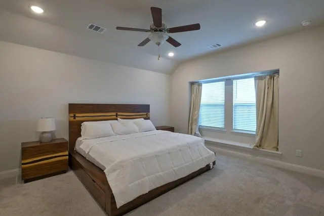a bedroom with a bed and a ceiling fan