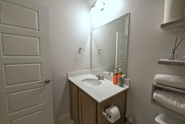 a bathroom with a sink toilet and vanity