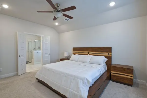 a bedroom with a bed and a ceiling fan