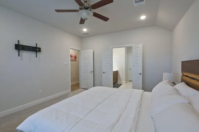 a bedroom with a bed and a chandelier