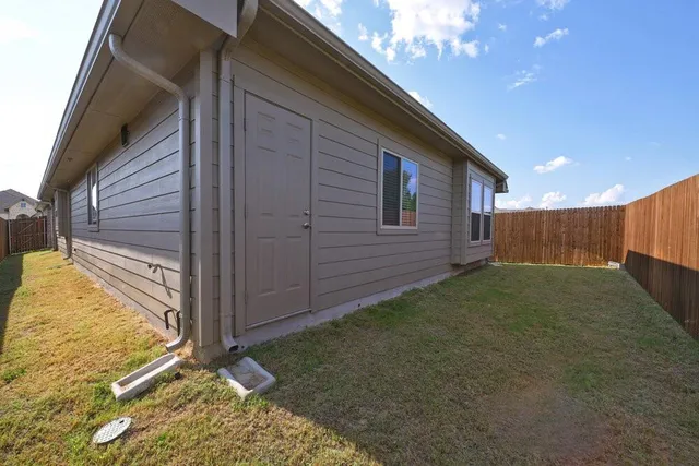 a view of a backyard of the house